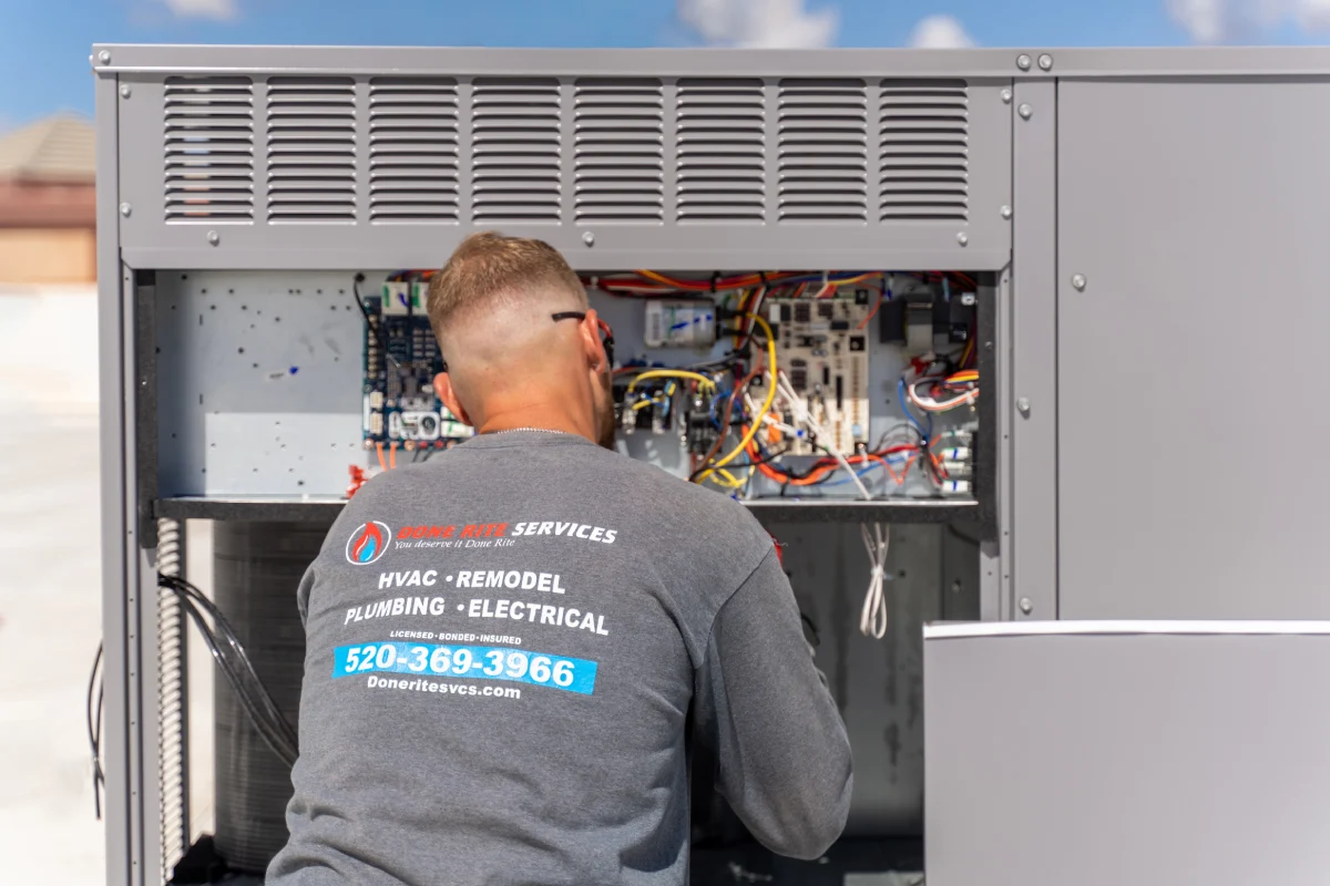 Done Rite Services technician working in the control panel of a rooftop unit