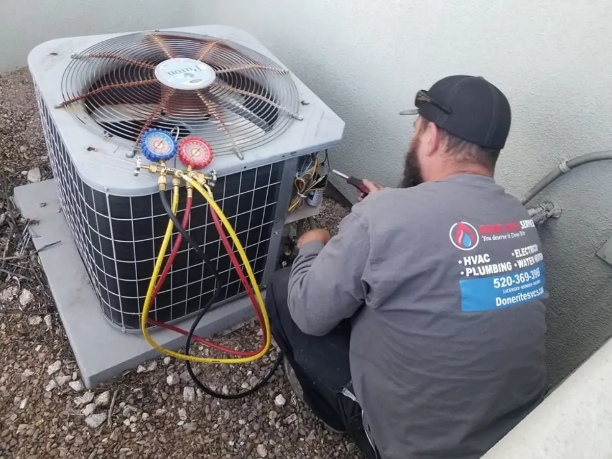 Done Rite Services technician taking refrigerant readings on a Tucson condenser