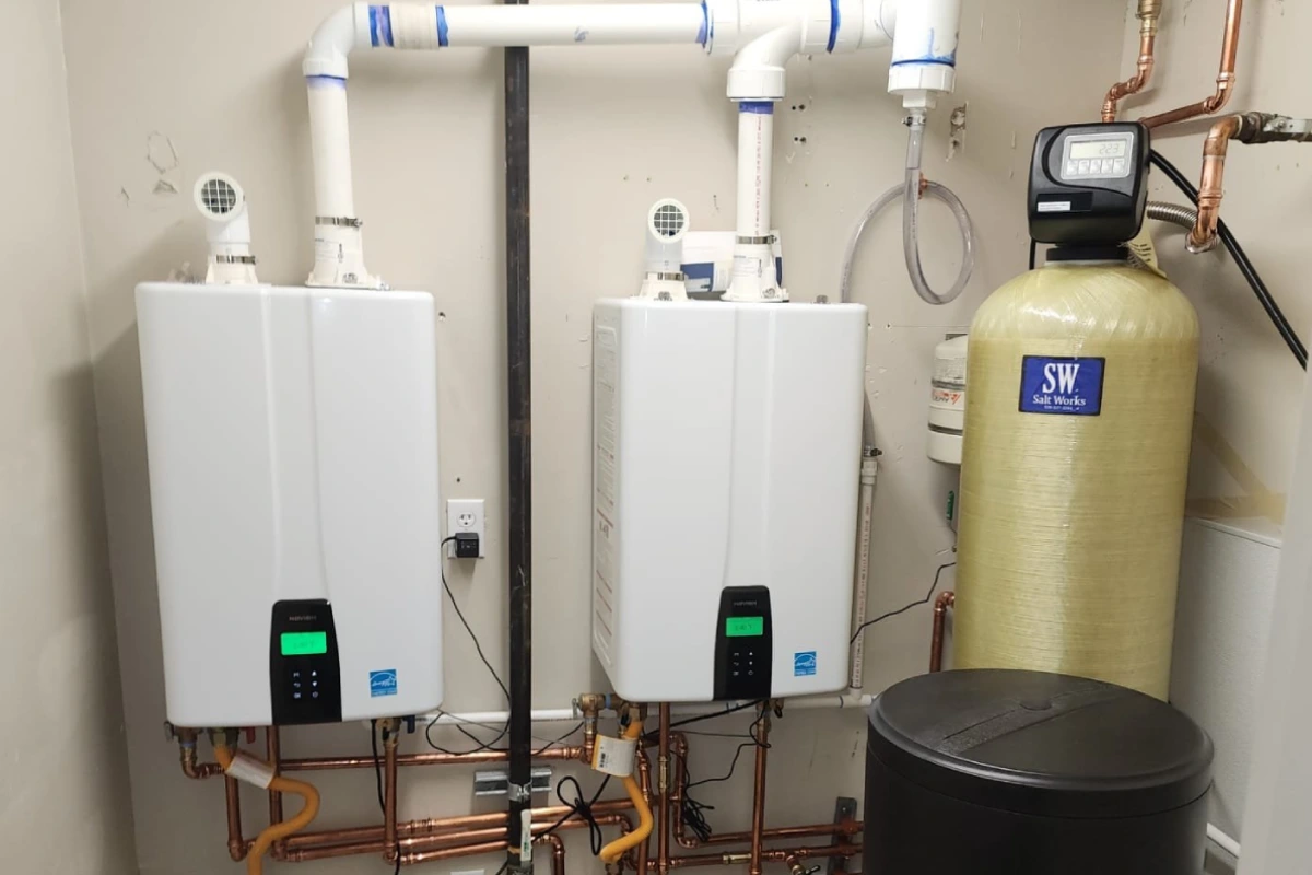 Two tankless water heaters installed side by side for higher capacity