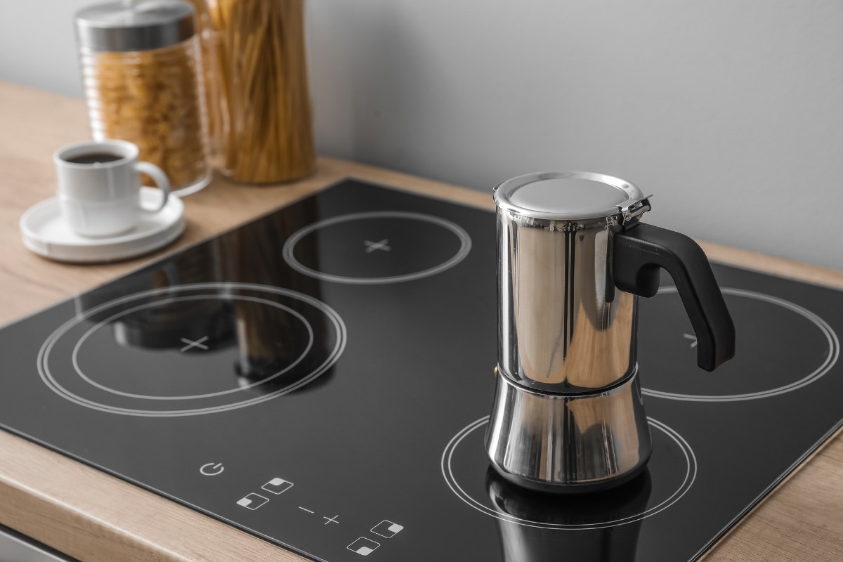 Induction cooktop with a stovetop espresso pot in a modern kitchen