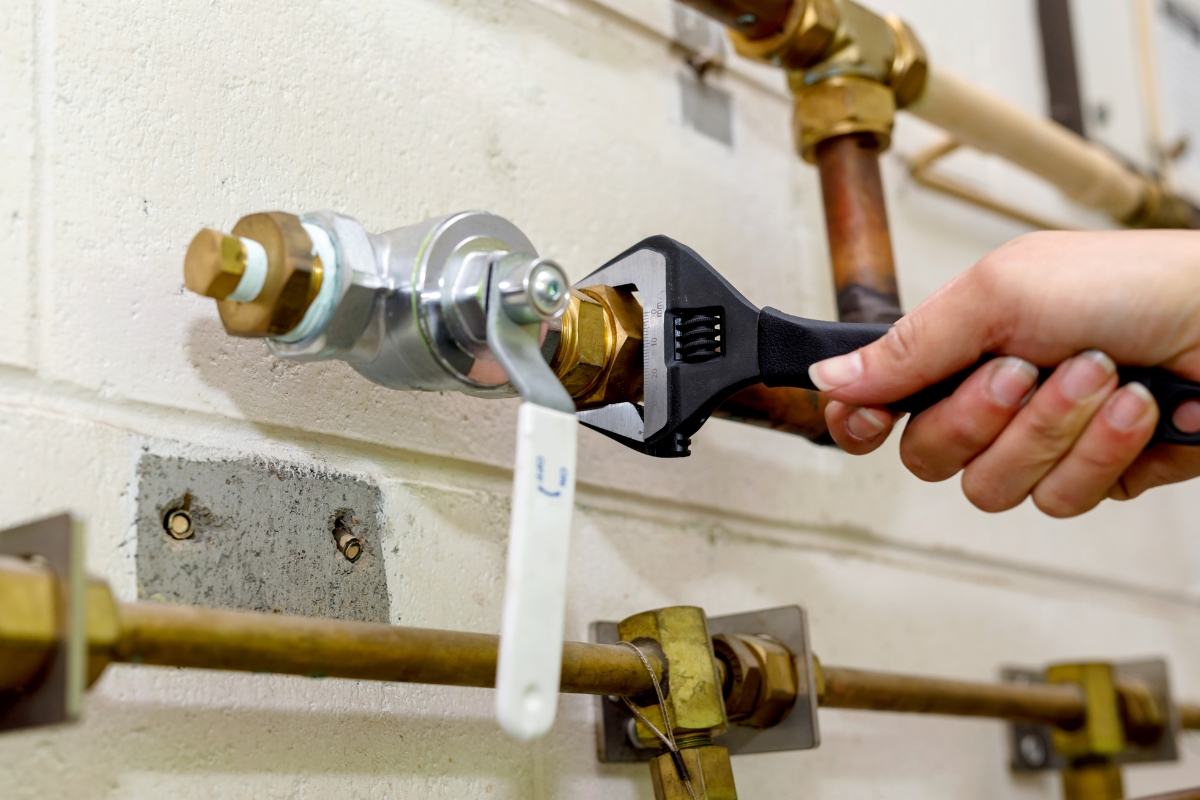 Gas line fitting being tightened during a repair in Tucson