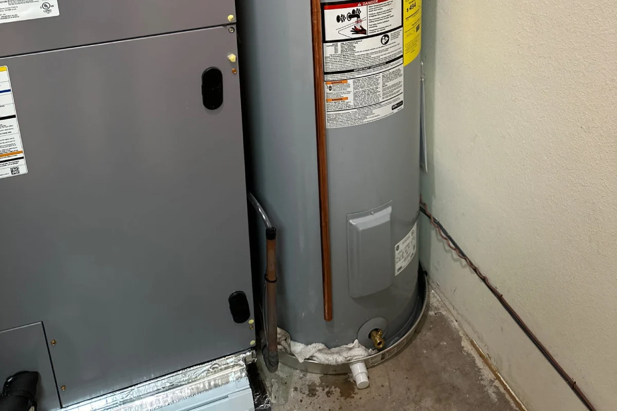 Technician testing the gas control valve on a residential water heater